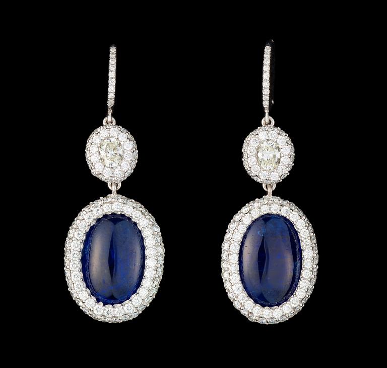 A pair of cabochon cut blue sapphire, 7.67 / 6.92 cts, and diamond earrings.
