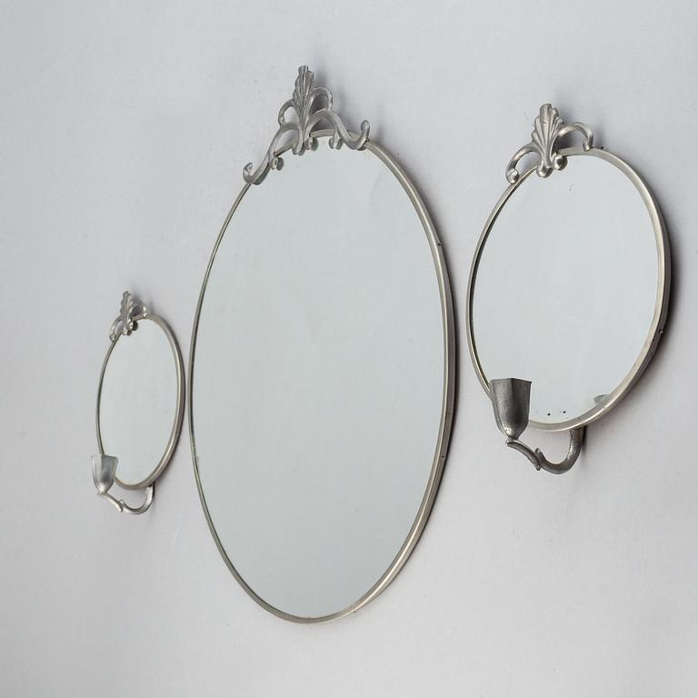 A set of a pewter mirror and two girandole mirrors.