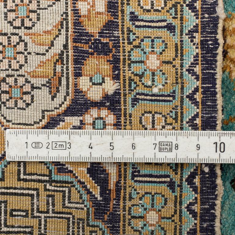 A RUG, an old silk Qum figural, ca 154,5 x 107,5 cm.