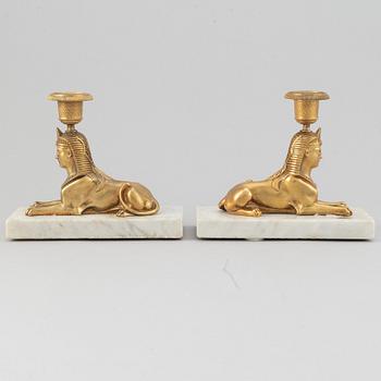 A pair of empire style 19th century candlesticks.