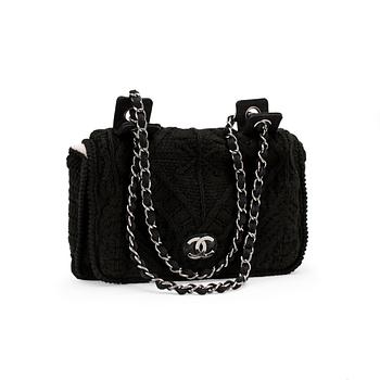 CHANEL, a black crochet flap evening shoulder bag.