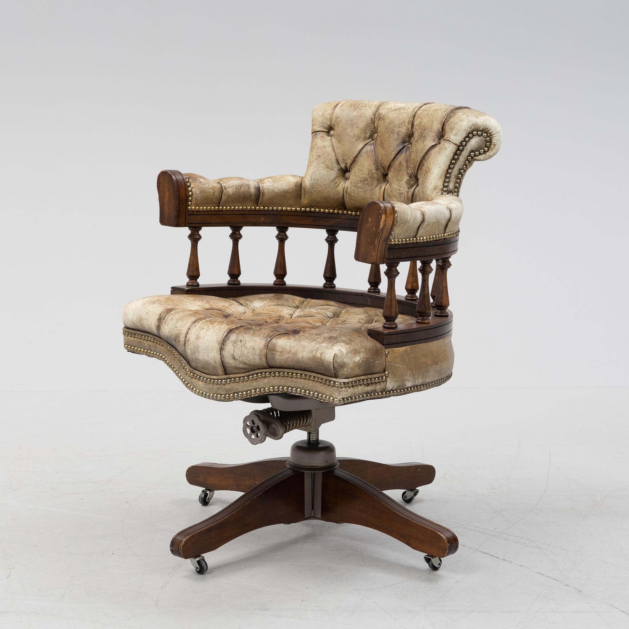 A 20th Century English mahogany and leather desk chair by Hillcrest Chair Actions.