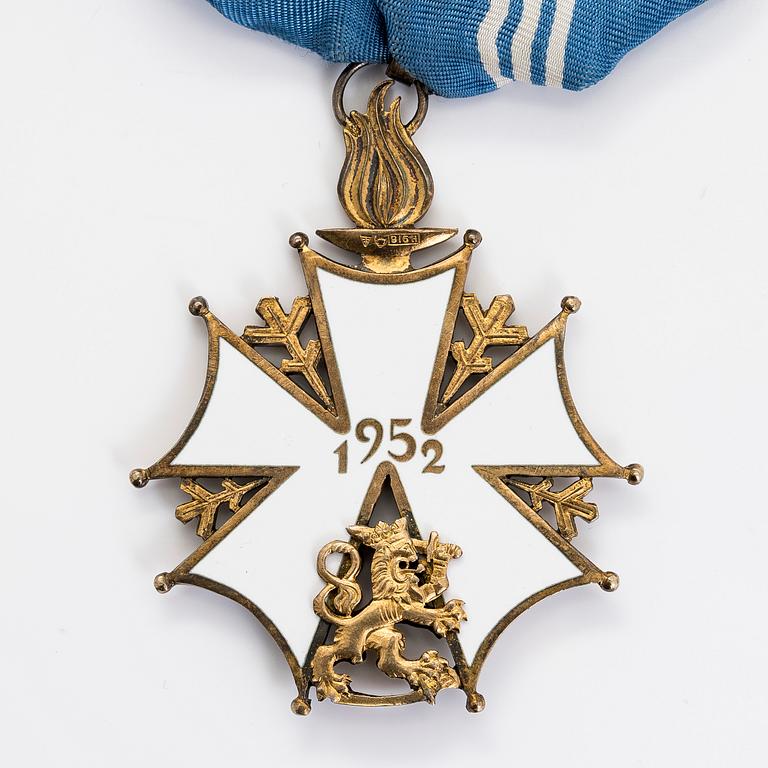The Finnish olympic cross, 1st class, silver and enamel. Tillander, Helsinki and a Guest of Honor pin.