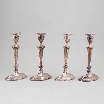 A set of four English 19th century silver-plated candlesticks.