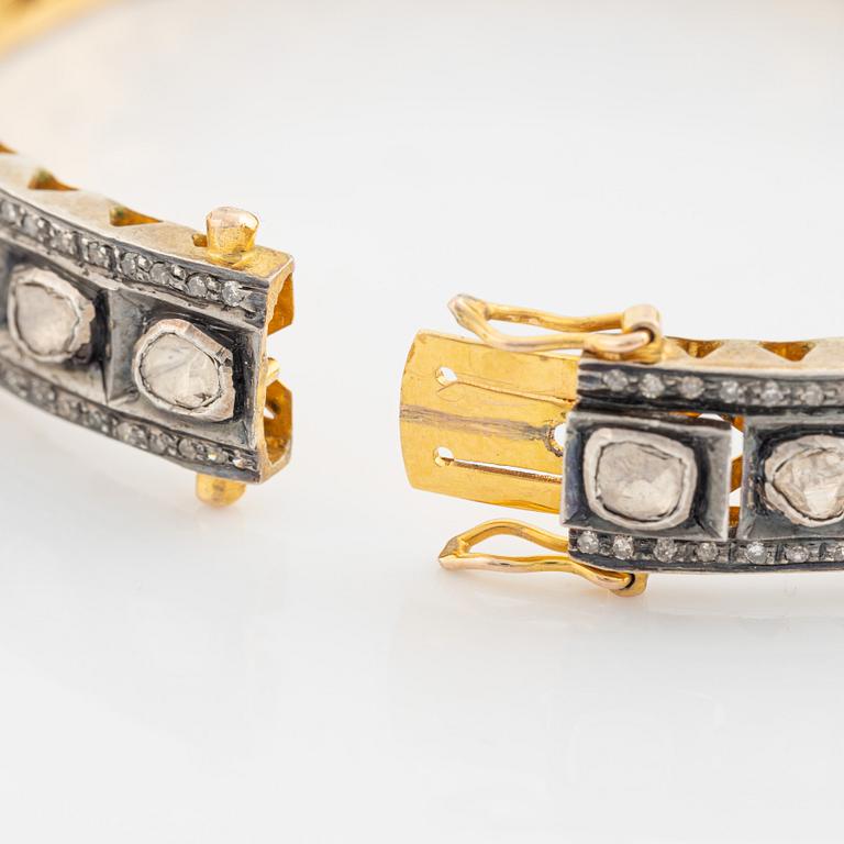 A faceted diamond bangle.