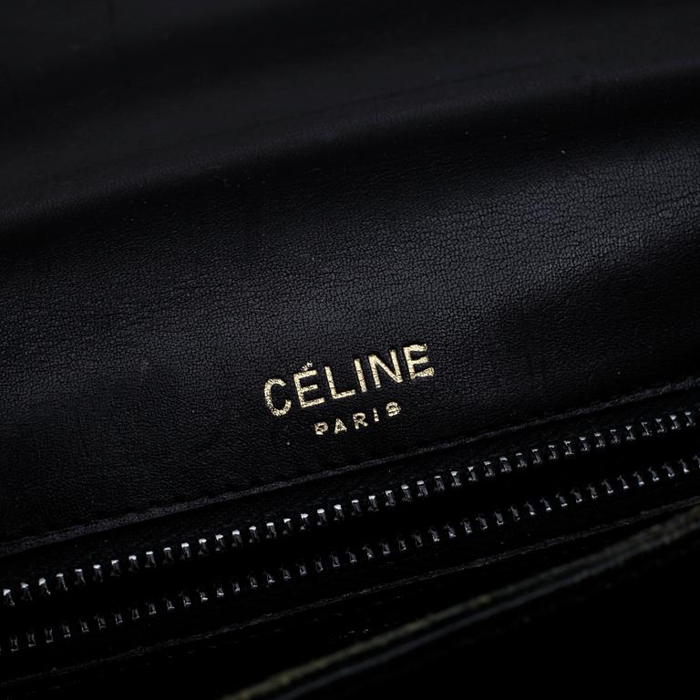 CÉLINE, a black patent leather shoulder bag.