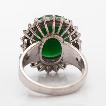 A palladium-plated silver ring with cabochon-cut jadeite and diamonds.