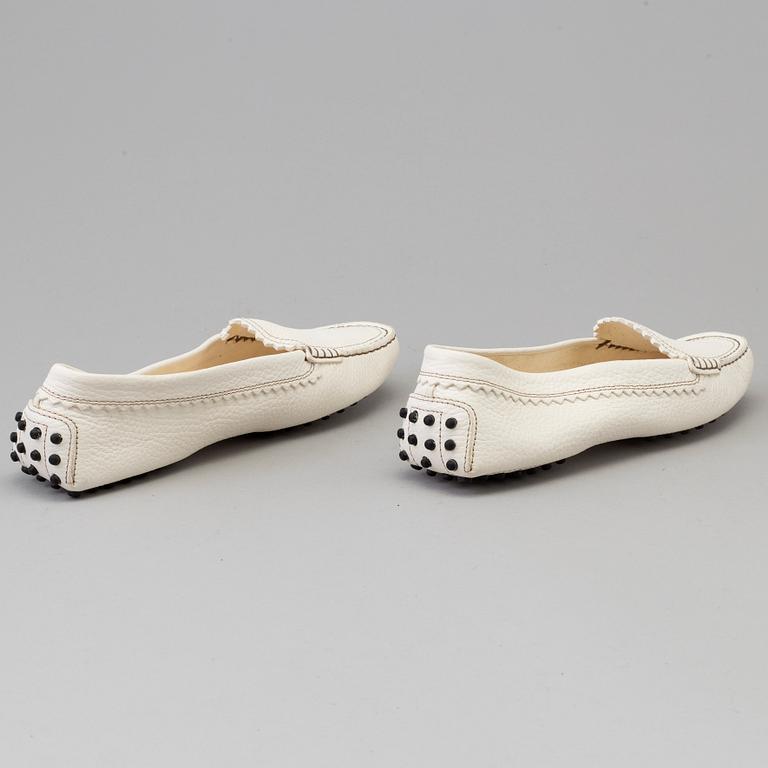 A pair of white leather loafers by Tod's.