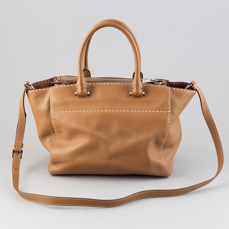 Prada, a leather handbag.
