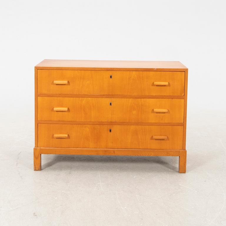 A 1940s elm chest of drawers.