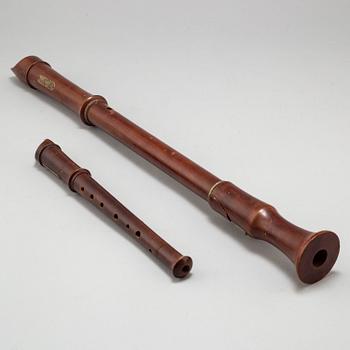 A brass shelf and two flutes, 20th century.