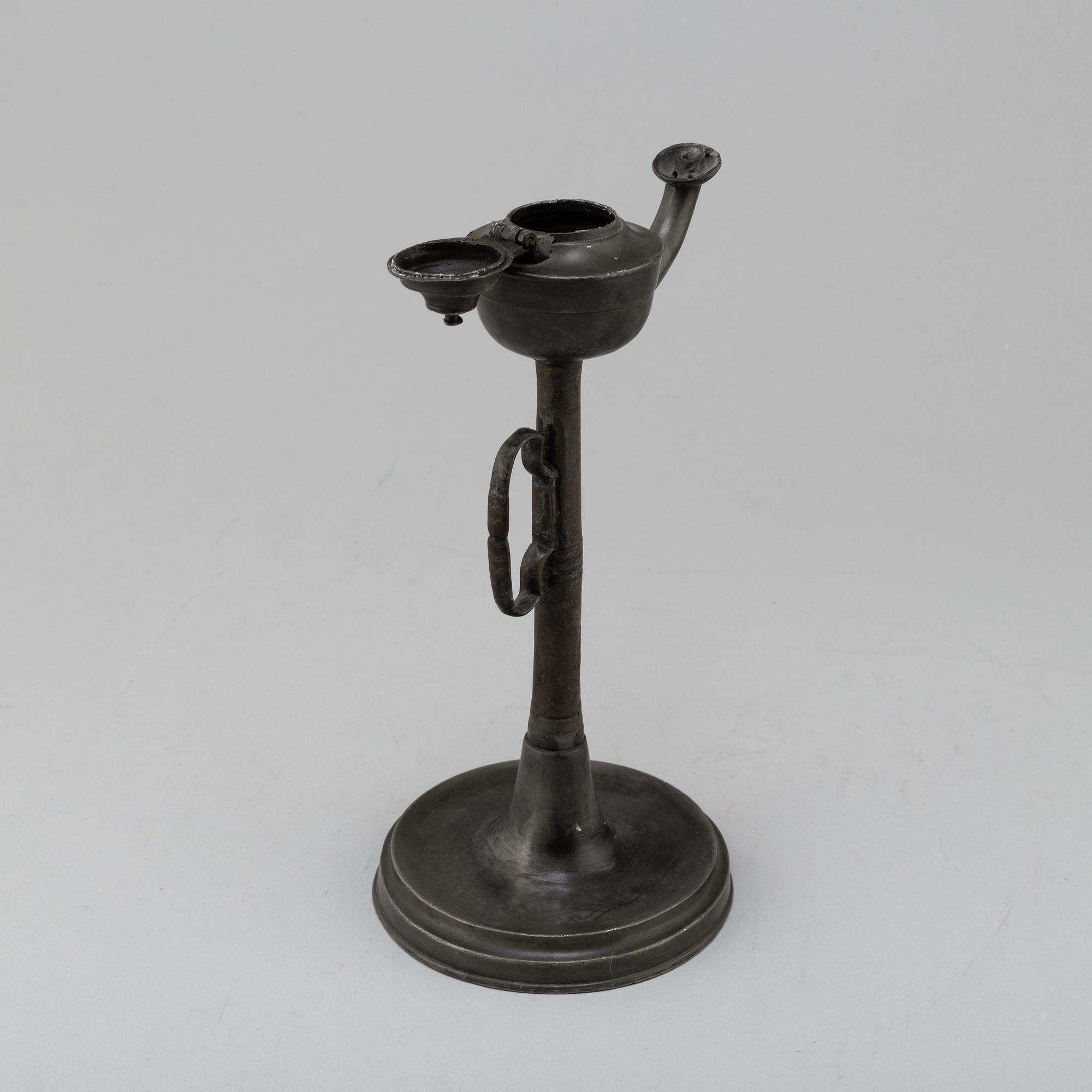 An 18th century pewter oil lamp.