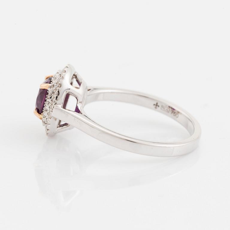 An 18K white gold ring set with a faceted ruby.