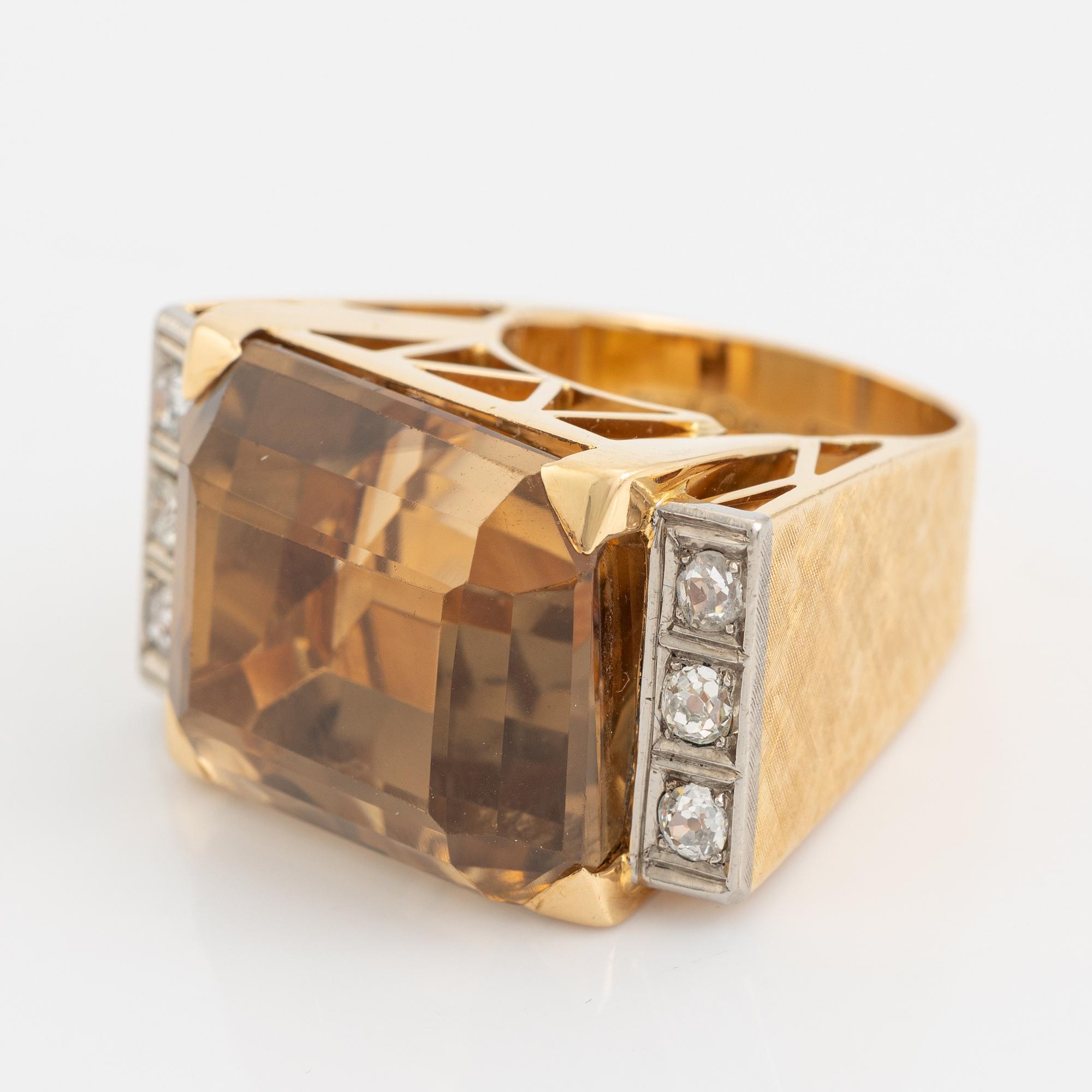 An 18K gold ring set with faceted quartz and old-cut diamons.
