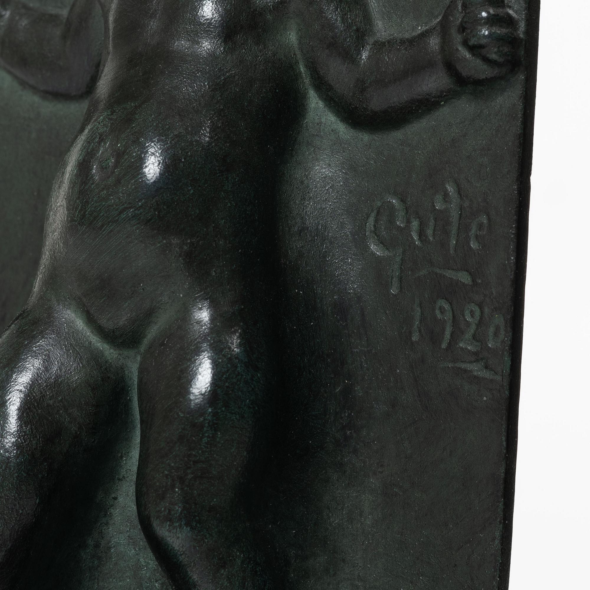 Axel Gute, a pair of patinated bronze bookends, dated 1920.