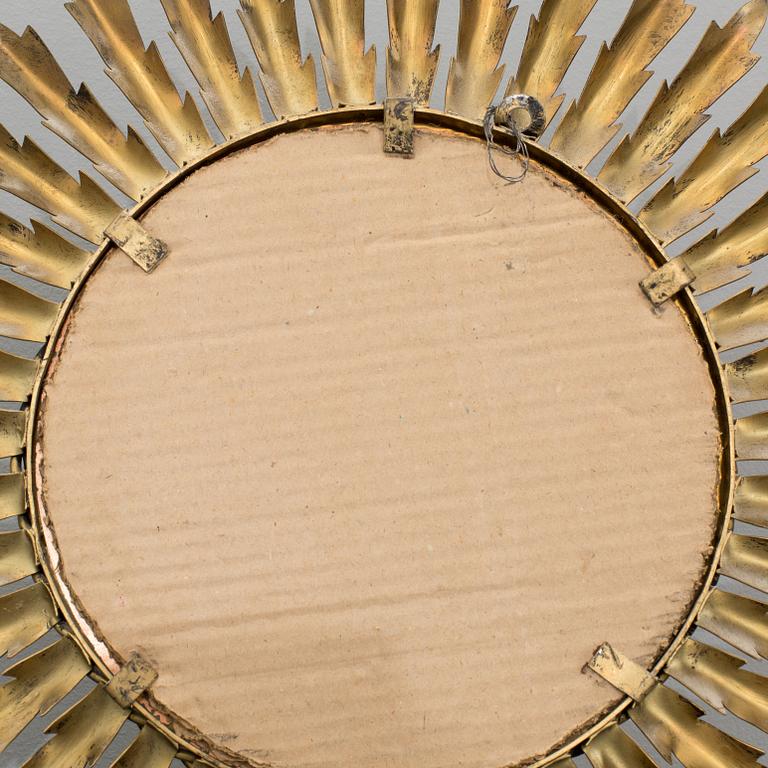 A 20th century metal sun mirror.