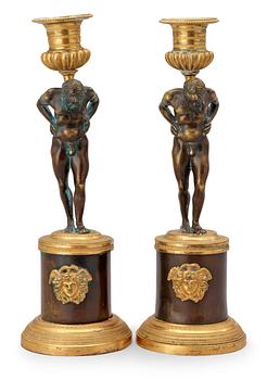 560. A pair of Empire early 19th century candlesticks.