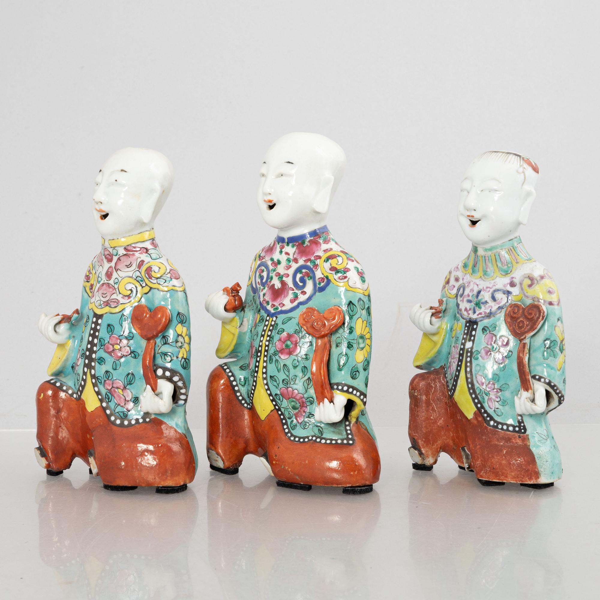 A group of three Chinese porcelain 'Laughing boys' figures, Qing dynasty and later.