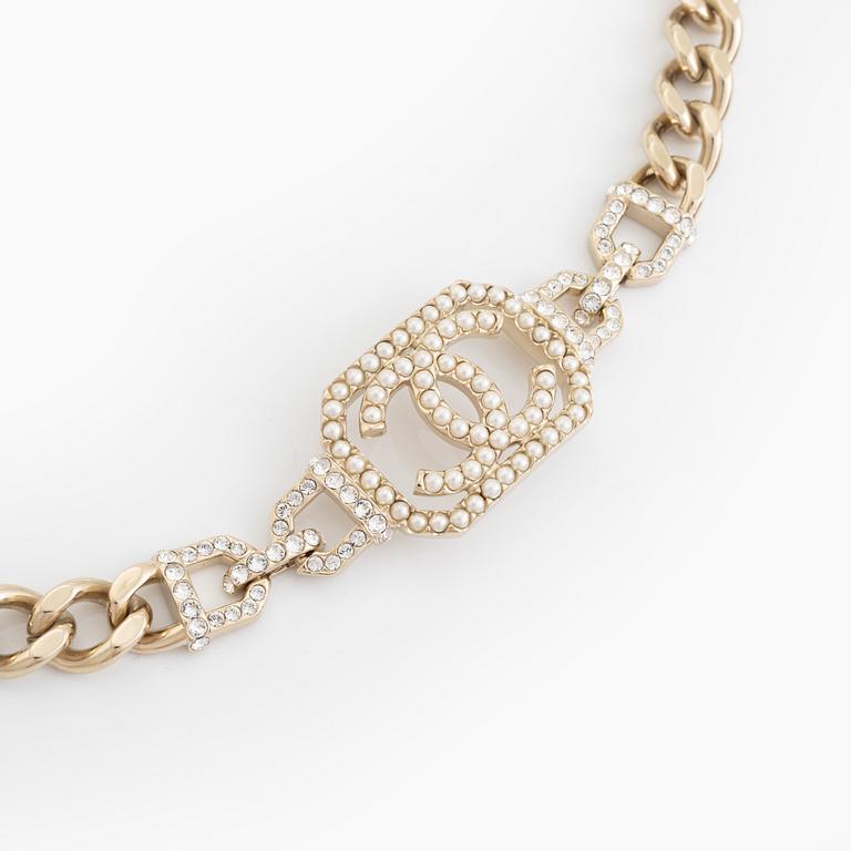 Chanel, a gold tone necklace with imitation pearls and rhinestones.