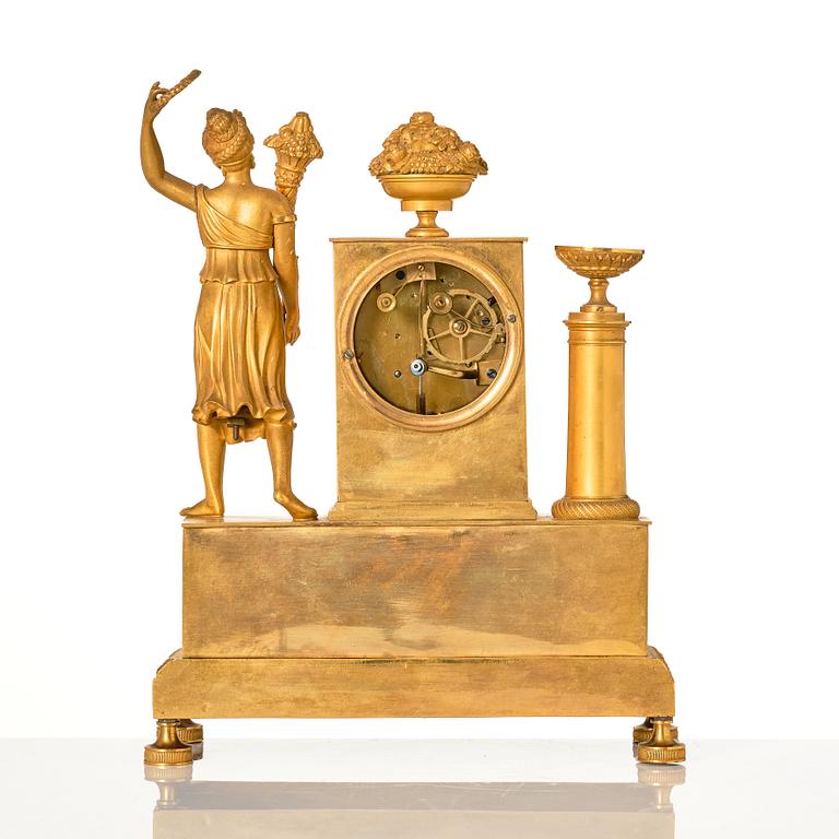 An Empire ormolu figural mantel clock, early 19th century.