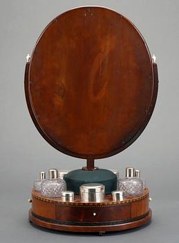 A Swedish Empire circa 1820 mirror on a stand for silver and glass toiletries.