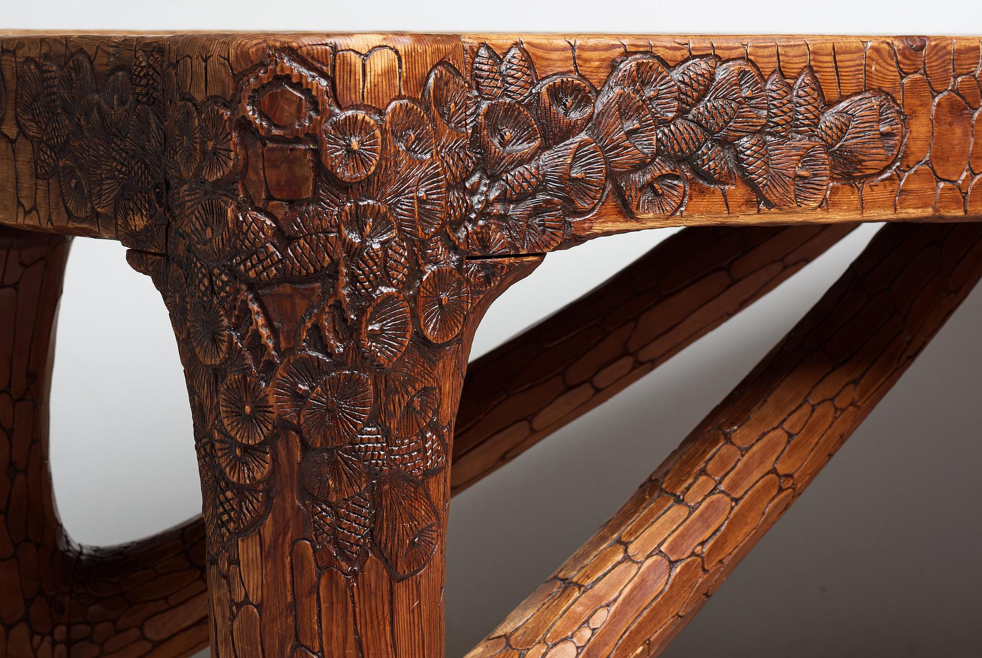 Gustaf Fjaestad, an Art Nouveau carved pine table, Arvika Sweden 1914, a double to the table in the Thiel Collection,