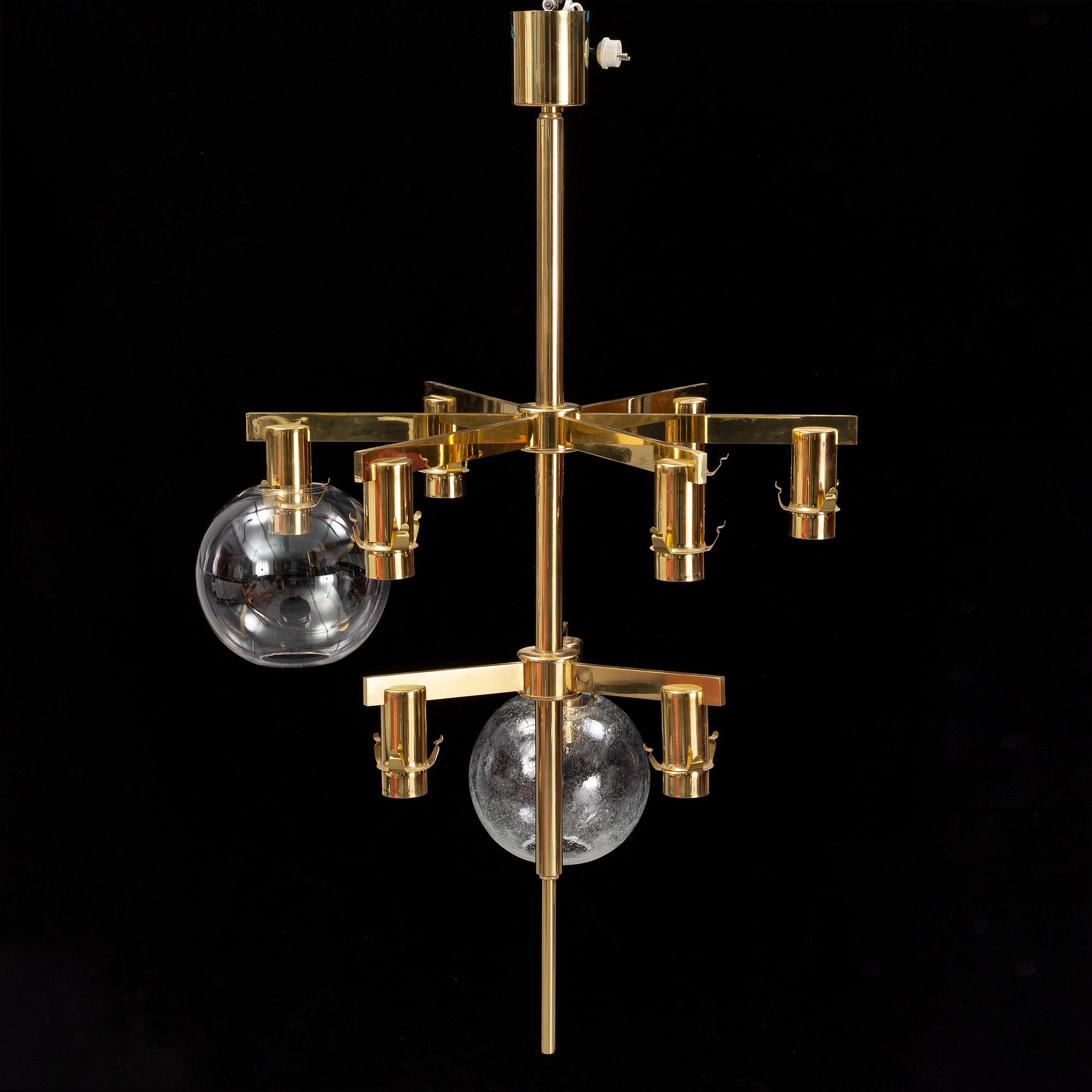 A brass chandelier with two glass globes by Hans-Agne Jacobsson, Markaryd.
