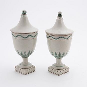 A pair of earthenware urns, 20th century.