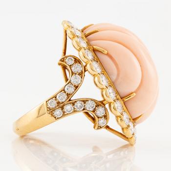 An 18K gold and coral Cartier ring set with round brilliant-cut diamonds.