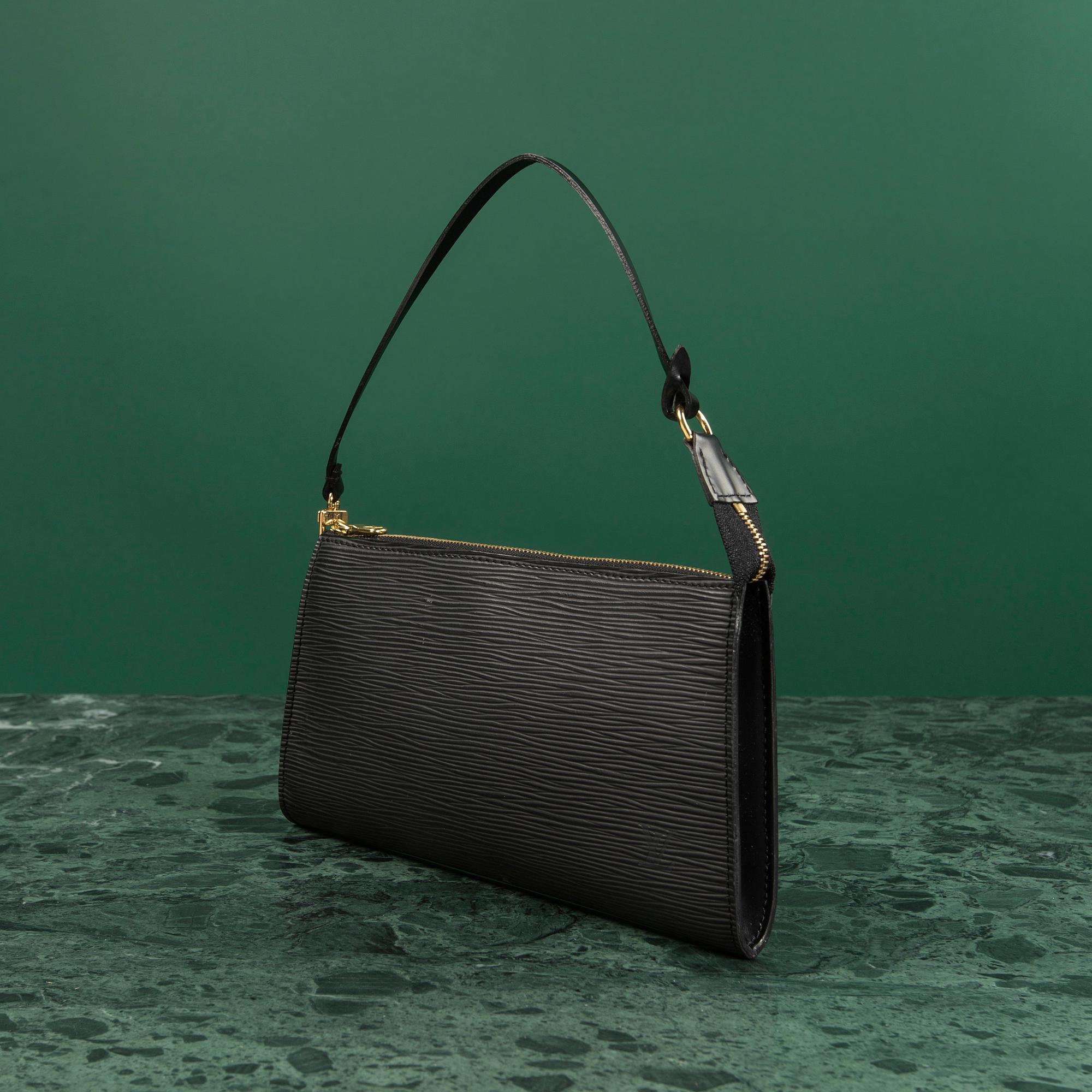 A bag  "Pochette Accessoires" by Louis Vuitton.