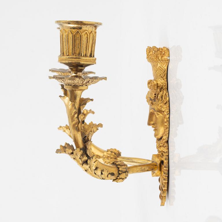 A pair of Empire-style ormolu two-light wall lights, 19th Century.