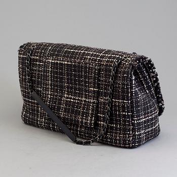 A tweed bag "Classic flip bag XL" by Chanel from 2016-2017.