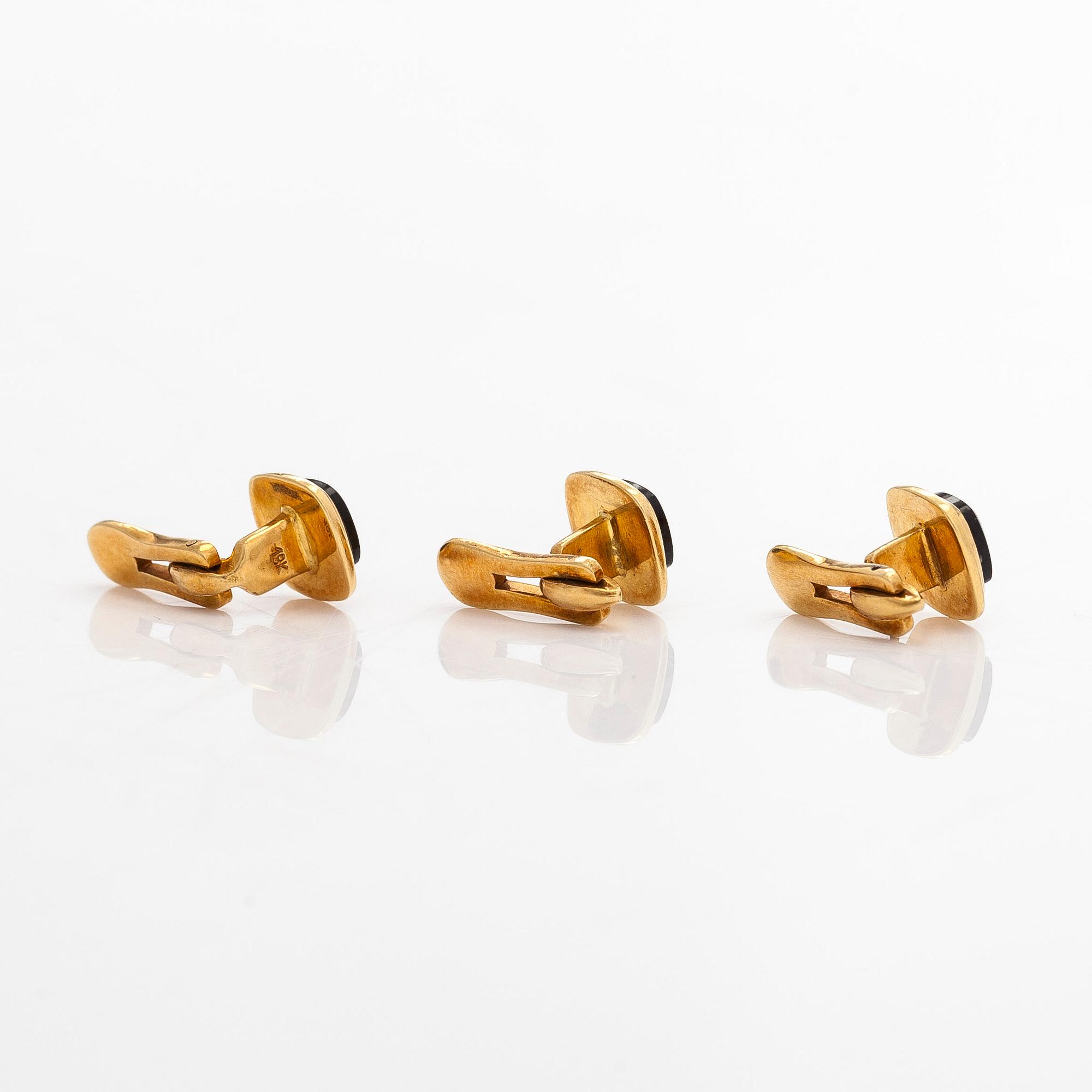 A pair of cufflinks and three shirt buttons,  18K gold and onyx.