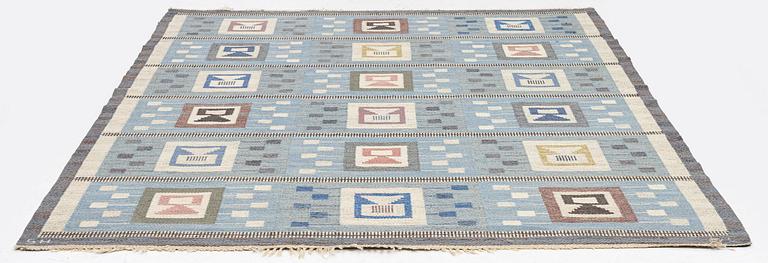 Edna Martin, a carpet, 'Flickorna i fönstret', flat weave, c 251 x 204 cm, signed SH.