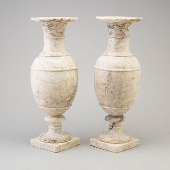 A pair of marble urns, circa 1900.