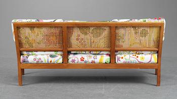 A Josef Frank cherry and ratten sofa for Svenskt Tenn, model 1100.