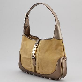 GUCCI, a metallic bag.