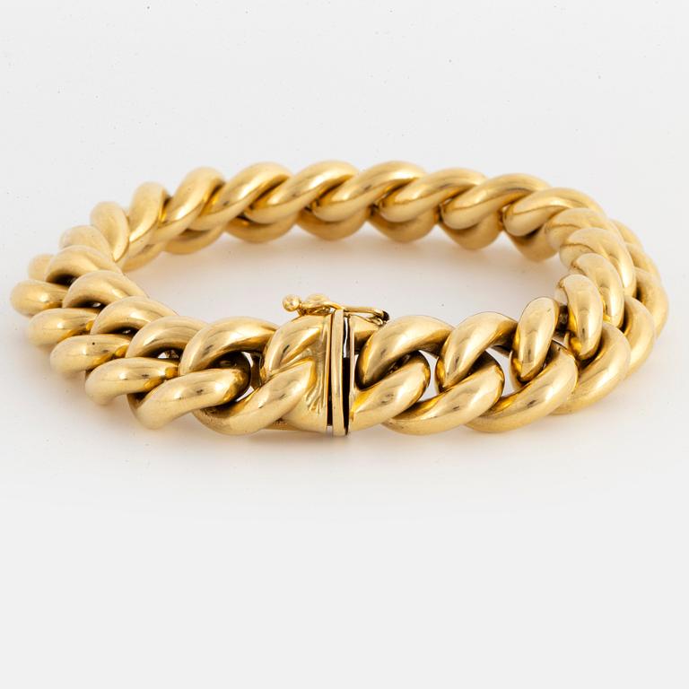 18K gold curb link bracelet.