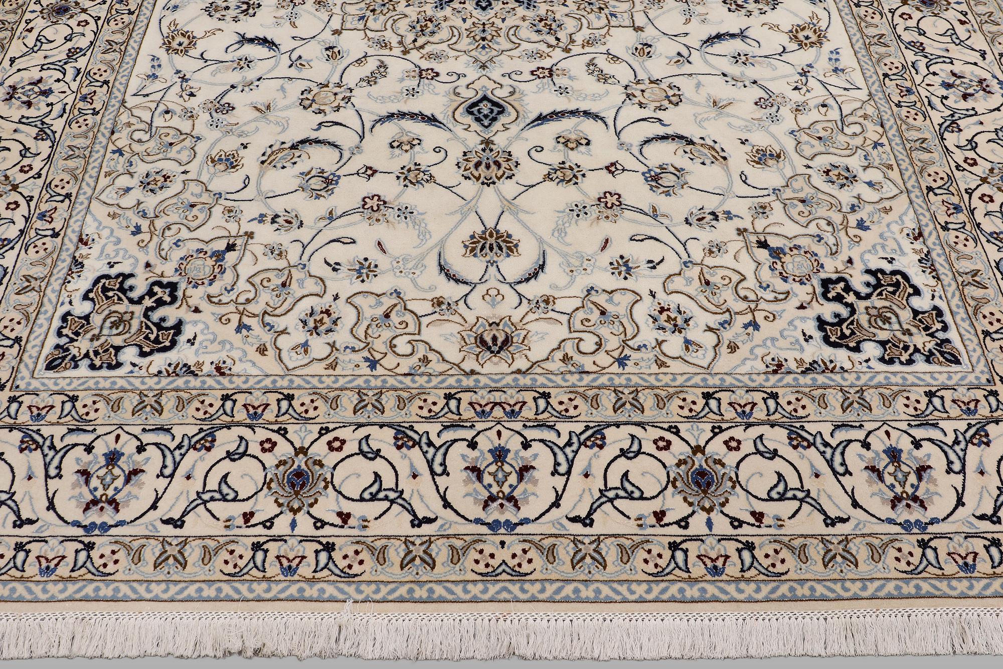 A Nain carpet, part silk, so-called 9 LAA, approx. 355 x 248 cm.