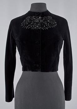 1520. A black velvet evening jacket with pearls by Carnegie.