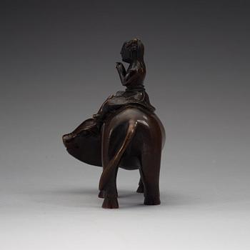 A bronze figure of a flute paying boy on a water buffalo, Qing dynasty (1644-1912).