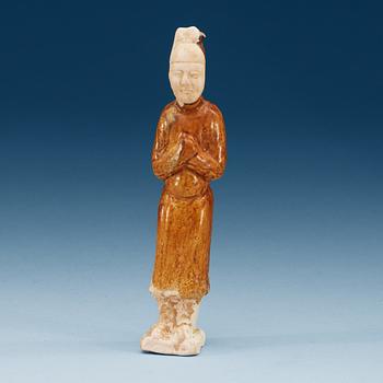 A yellow glazed pottery figure of a court attendant, Sui dynasty (589-618).