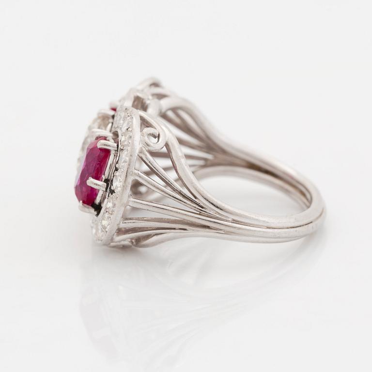 An 18K white gold ring set with faceted rubies and a round brilliant-cut diamond and eight-cut diamonds.