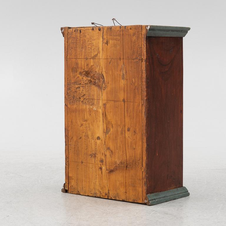 A painted wall cabinet, dated 1817.