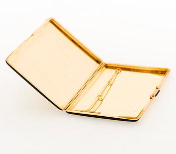 A Cartier Art Deco cigarette case in 18K gold with black enamel and set with sapphires.