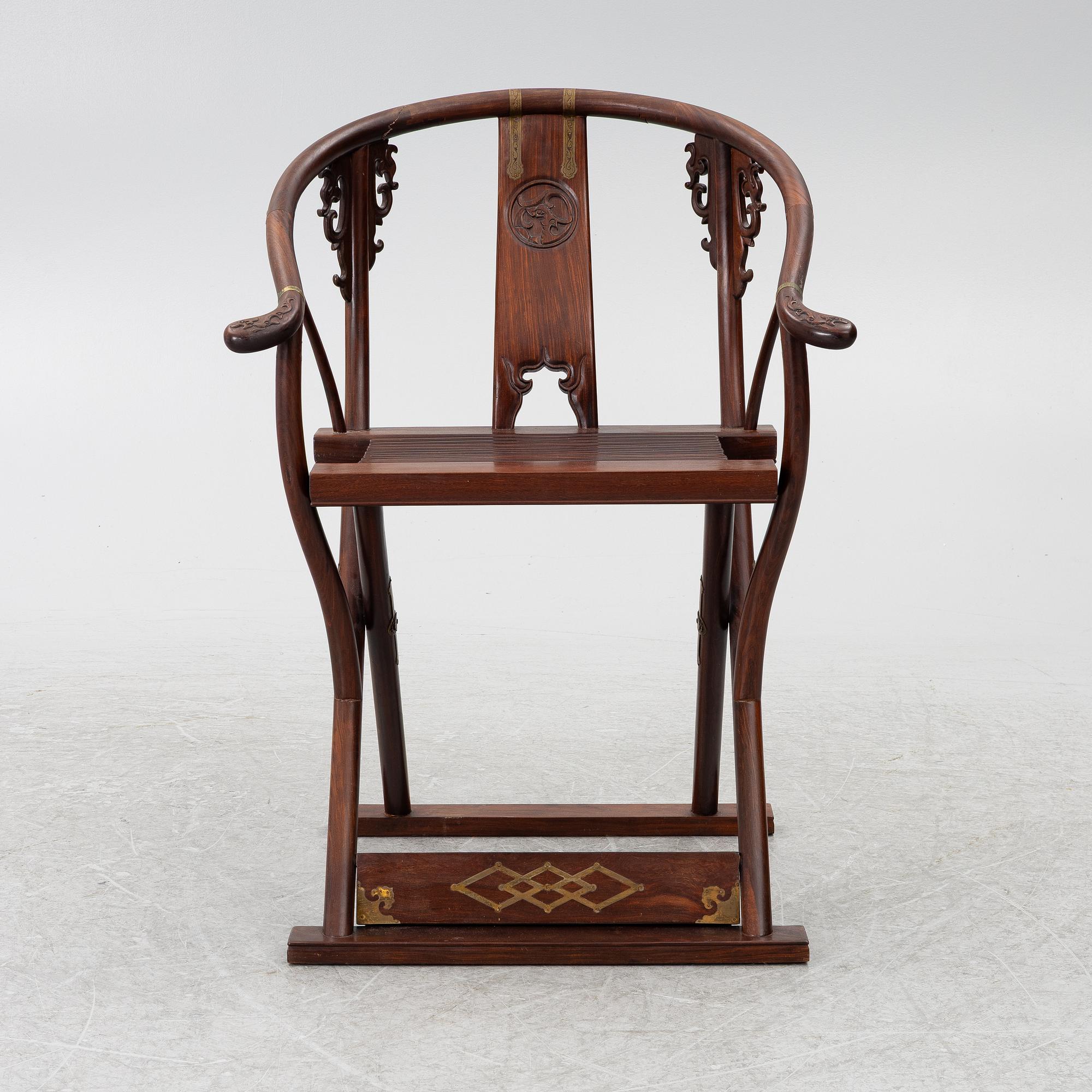 A Chinese hardwood folding chair, 20th century.
