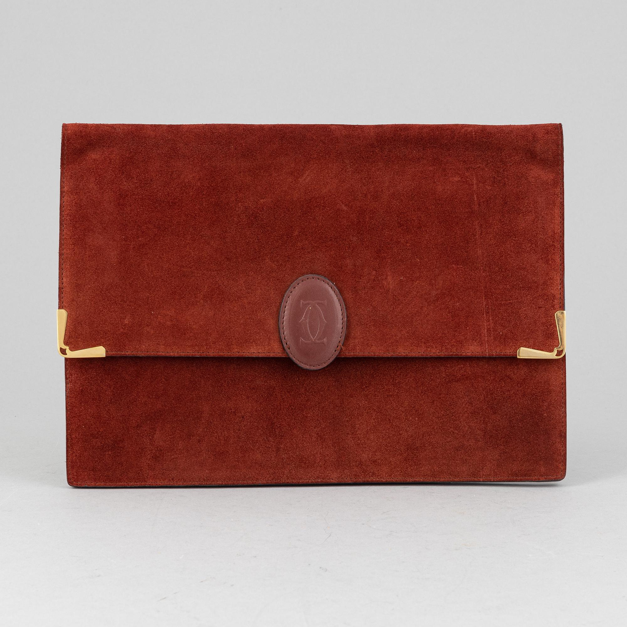 Cartier, a red suede clutch.