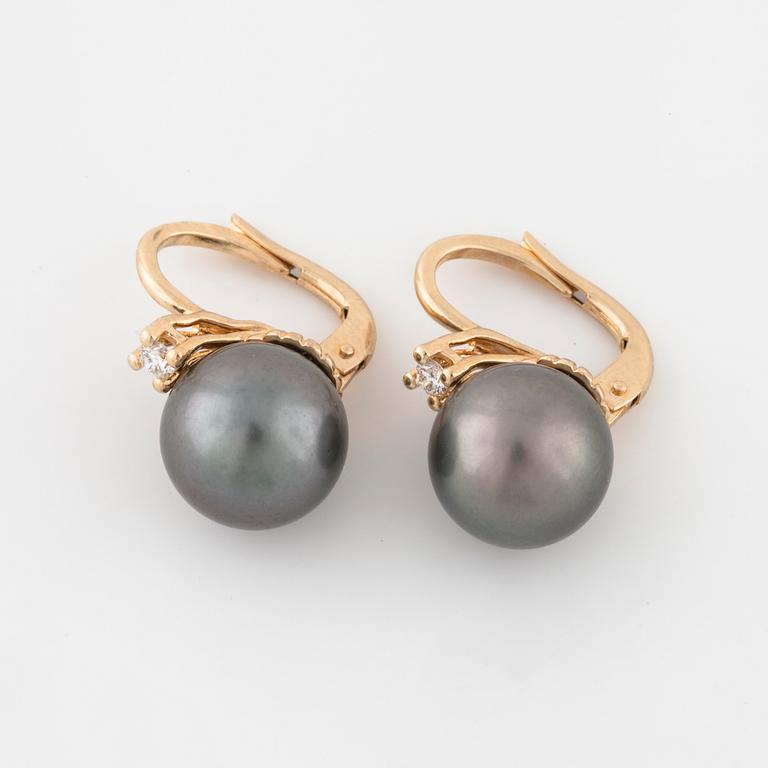 A pair of cultured Tahiti pearl and brilliant cut diamond earrings.