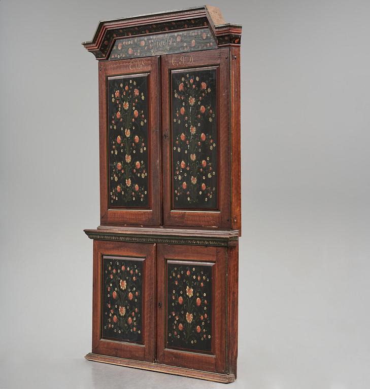 A Swedish polychrome painted folk art corner cabinet, dated 1818.