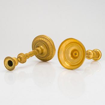 A pair of mid-19th-century gilded bronze candlesticks.